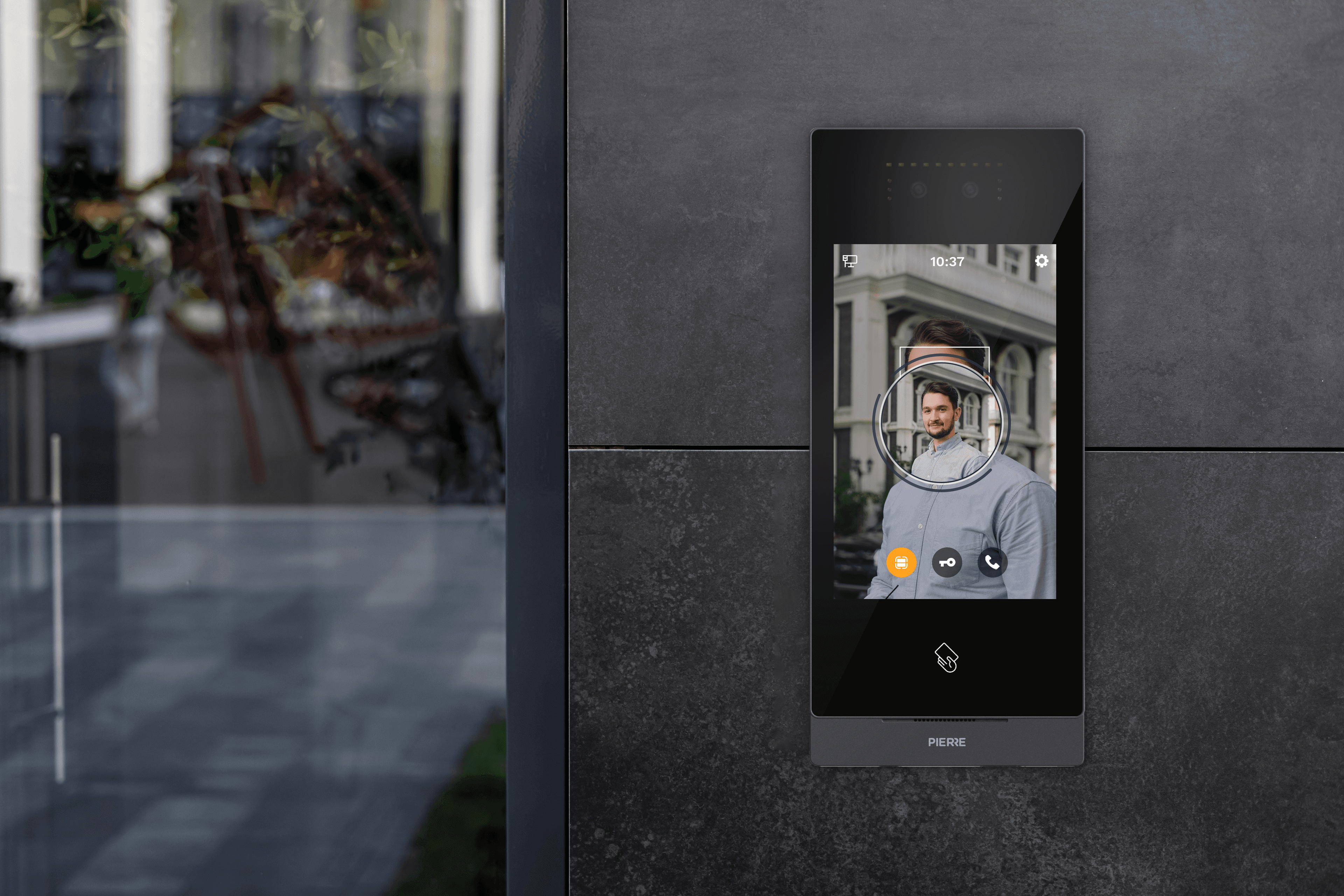 PIERRE BOSTON Intercom mounted by entrance, showing face recognition on built-in display